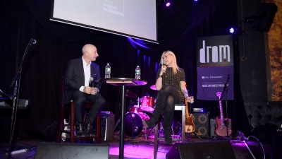 Larry Miller and guest Natalia Nastaskin sit together on stage at an NYU Steinhardt Music Business event