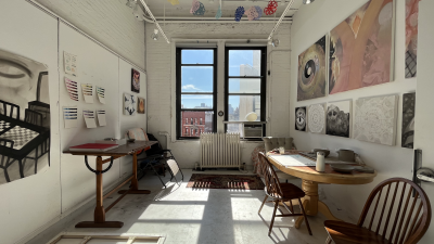 A shot of an MFA studio inside the Barney Building. Two windows appear and sunlight streams in, filling the studio with light.