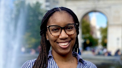 headshot of danisha in front of fountain 