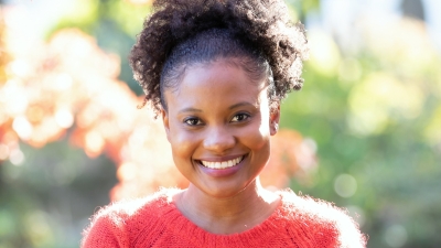 headshot photo of Shari-Lee Carter, smiling and wearing a red sweater