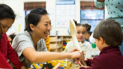 Student teacher working with students in an elementary classroom