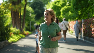 Older woman walking in the park on a sunny day