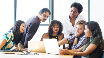 Students sitting around a laptop