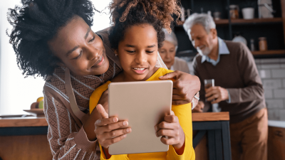 Parent and child playing on digital devices