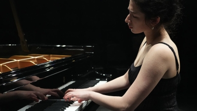 doctoral student playing the piano