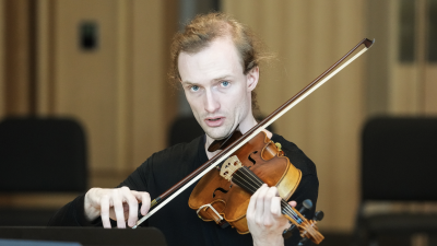 violinist looking intensely into camera