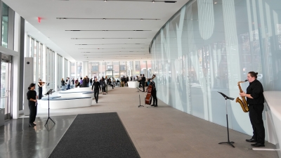 NYU Students playing instruments in Paulson Center lobby for grand opening event