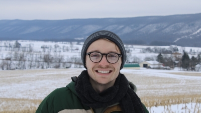 Photo of Anthony during the winter season, snow and mountains in background