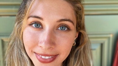 Photo of Kelly Gillespie; Smiling, short, blonde hair is half-up, half-down; wearing a black shirt.