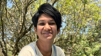 woman smiling with trees in the background