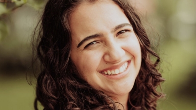 woman with curly hair smiling