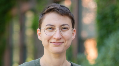 person with glasses smiling