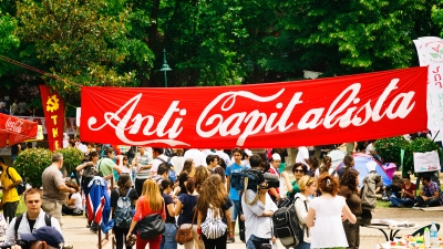 A banner reading "Anti Capitalista" is shown in the same color and fonts used in the Coca Cola branding