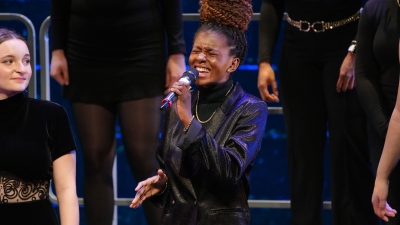 Student singing solo during winter choral concert