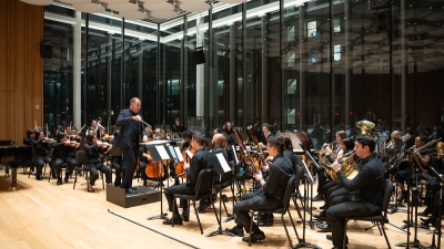 Conductor leading orchestra. 