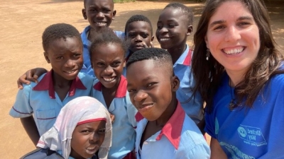 Javi smiling with school children from Senya Beraku, Ghana