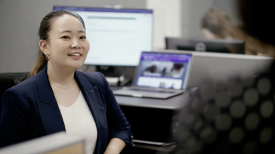 Photo of INTE Masters Alumni, Yui Takahashi, sitting at work desk