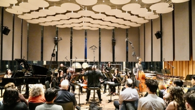 Orchestra playing under the light ceiling in Paulson Center