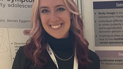 woman with pink and blonde streak hair smiling 