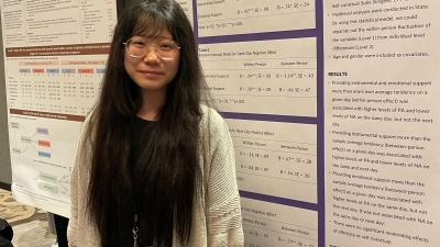 woman on front of poster wearing glasses