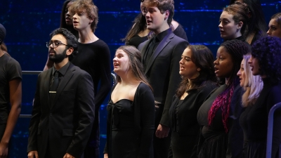 Choral group singing on bleachers