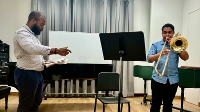 Professor doing private lesson with brass student