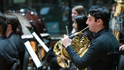 Student playing french horn
