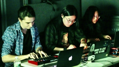 Three Music Technology students working on audio machines