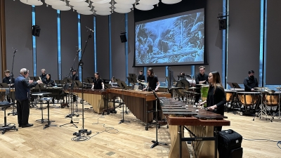 Percussion students rehearsing in front of screen created in screen scoring program