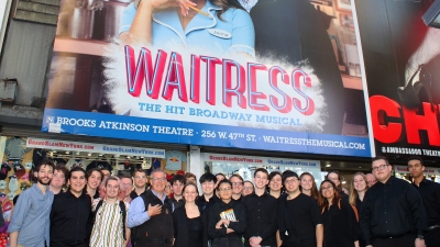 Large group of students in front on Waitress sign