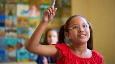 Child raising her hand in class