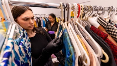 Two students look through the archive of costumes