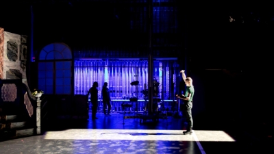 A technician stands on stage at the Cantor Theatre.