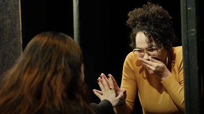 Two drama therapy students laughing as they complete a mirroring exercise. 