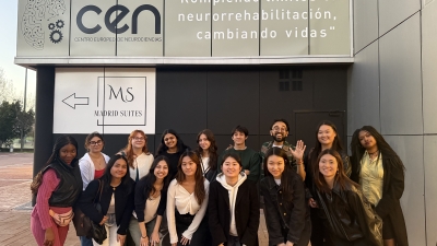 A group of students poses in front of a Spanish neuroscience center.