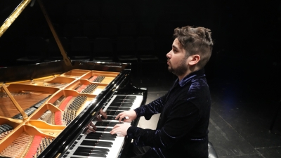 A man playing at a piano.