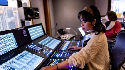 Student working in Music technology lab with lit up equipment