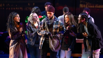 Four angry performers gathered around one who is dealing drugs