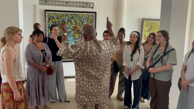 man talking to a group of students