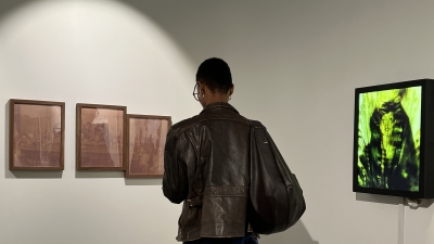 A student looks at artwork in NYU's Latinx Gallery at 20 Cooper Union.