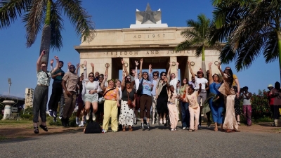 People jump in front of a monument