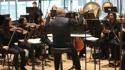Chamber group practicing and being led by conductor