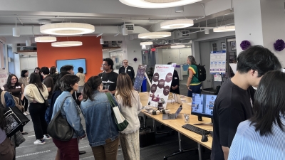 Students explore different presentations at an expo. 