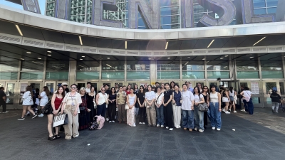 A group of students gather in front of the Staten Island Ferry Terminal.