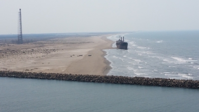 A cargo ship is seen making ground on a beach