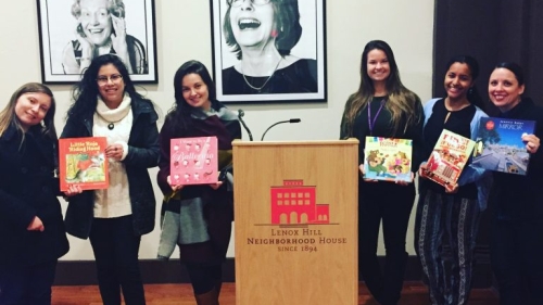 Students holding children's storybooks.