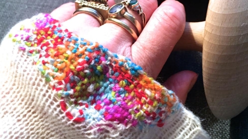 Kate Sekules mending, hand in sweater