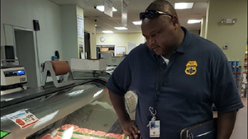 Joseph Ndungu inspecting packages of meat.