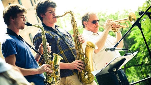 three jazz musicians playing outside