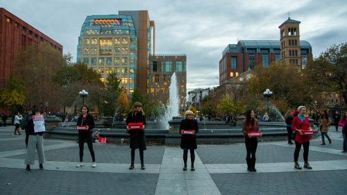 Students with public art in park